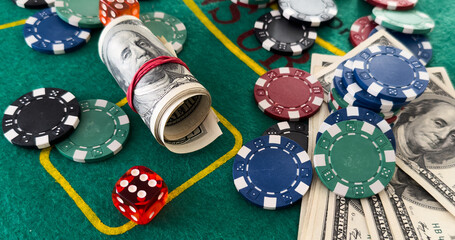 casino chips and dices stacking on a green felt