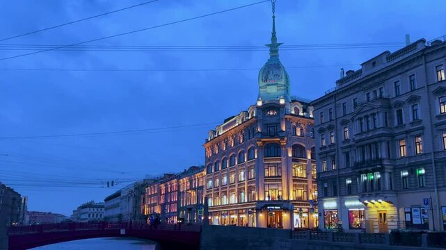 Russia, April 9, 2024: Boats on the canal in St. Petersburg in spring. Bridges and historical buildings on the river embankment, people walking along the embankment. Reflections of houses in the water