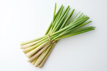 A bunch of fresh lemongrass stalks tied together with a rubber band, set against a plain white background