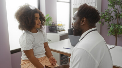 Fototapeta premium Doctor consulting young girl in pediatric clinic with medical tools on desk, emphasizing care, professionalism, and comforting environment for child and healthcare.