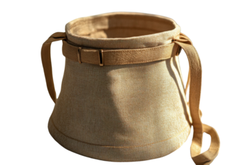 A tan-colored, cylindrical bucket bag with a cinched top, a wide strap, and side loops for an additional strap is displayed on a transparent background.