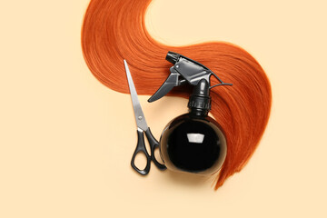 Ginger hair strand, scissors and sprayer on color background