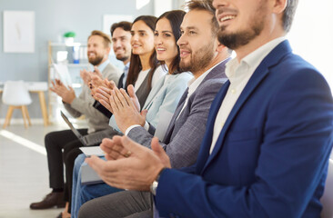 Close up shot of a diverse business people applauding during an office event. The teamwork-driven...