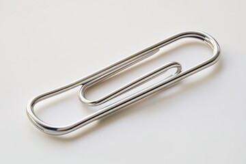 A single silver paperclip isolated on a white background