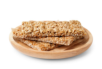Plate with tasty kozinaki on white background