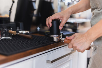 Women barista making coffee in a coffee shop.