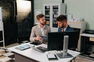 Male Operations Manager Holds Meeting Presentation for analysis graph company financial.