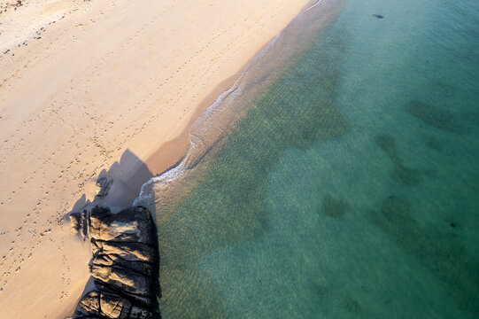 abstract aerial view of rocks and clear sea patterns