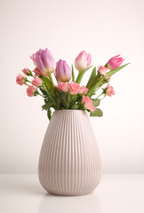 White spring tulips in a vase on a white table. Mock up for displaying works