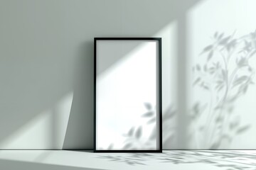 Blank vertical frame mockup with shadows of leaves on a white wall, concept for minimalist branding, social media post, and website design