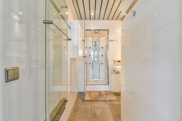 A stylish modern bathroom featuring a sleek shower with glass walls, elegant tiles, and contemporary lighting, creating a bright and spacious atmosphere.