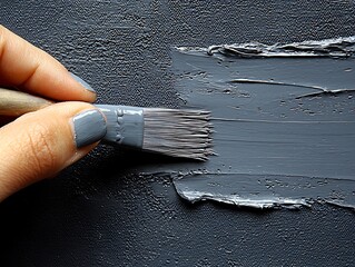 Grey paintbrush stroke applied to canvas.