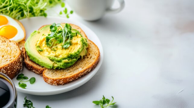 Plate of avocado toast with a side of eggs and a cup of coffee. The plate is set on a white table with a few herbs and a cup. Concept of a healthy and balanced breakfast