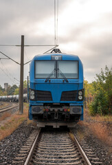 Electric locomotive transporting fuel storage tanks, front view