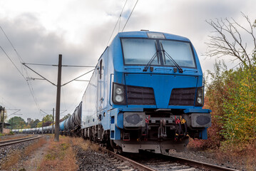 Fototapeta premium Electric train carrying fuel storage tanks, in Baden Wurttemberg, Germany