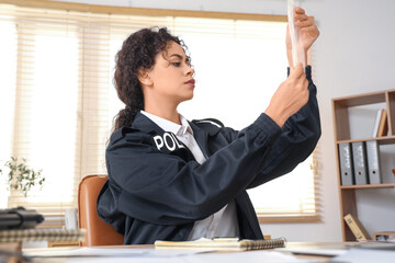 African-American police officer working in office