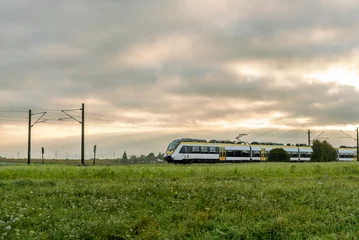 Fotobehang Donkergrijs Sunrise landscape with a passenger train traveling in Baden Wurttemberg,  Germany  © YesPhotographers