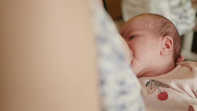 Breastfeeding newborn baby. Close-up view