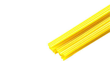 Uncooked Yellow Spaghetti Stack, Minimalist Food Ingredient on White