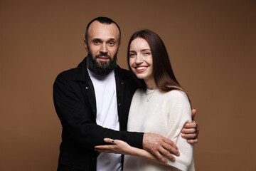 Portrait of happy daughter and father on brown background