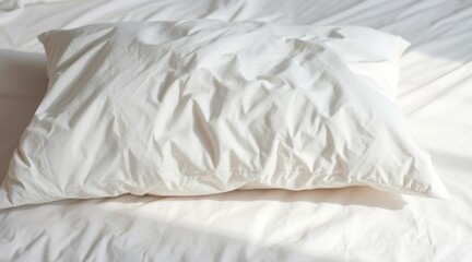 Obraz premium Comfortable White Pillow Placed on a Textured White Sheet