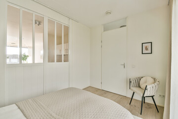 A contemporary bedroom featuring a stylish bed, soft textures, and minimalistic design elements. The space promotes tranquility and simplicity.