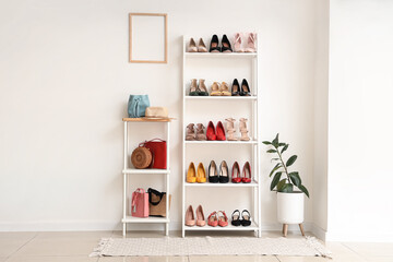 Interior of light room with shelf units, female shoes and bags