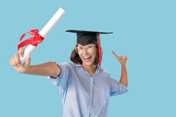 Happy female graduating student  with diploma on blue background