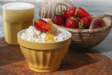 Fresh strawberry curd cheese, served in a yellow bowl along with a bowl of fresh strawberries. Healthy Breakfast.