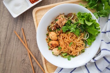Steamed  thin noodles without soup in white bowl on wooden background , top view