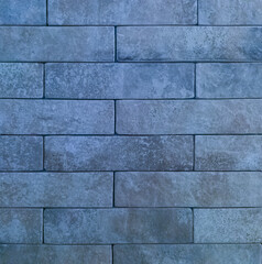 The brick wall is blue. Brick blue background. The texture of the blue brick.