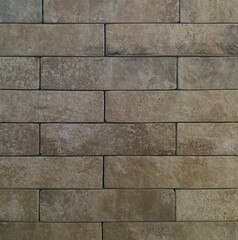 The brick wall is grey. Brick grey background. The texture of a gray brick.