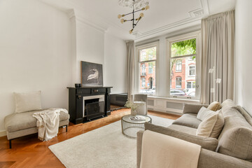 An elegantly designed living room featuring contemporary furniture, large windows, and warm lighting, creating a cozy atmosphere for relaxation and gatherings.