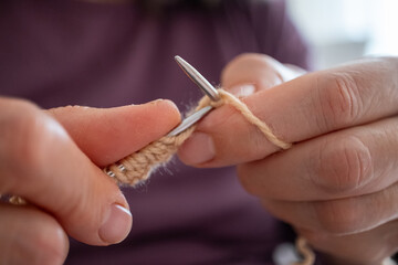 knitting a scarf with needle and crochet hook	