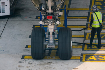 image showcases aircraft landing gear with large tires, highlighting maintenance process airport....