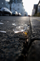broken glass on the street. ne years eve. morning backlight. concept of broken friendship