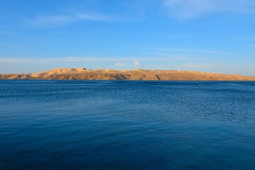 View of Pag island across the Velebit channel in the Adriatic sea in Croatia