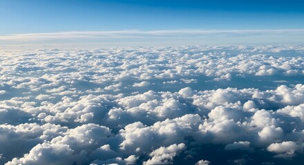 Naklejka premium Aerial View of a Sea of Cumulus Clouds Under a Brilliant Blue Sky