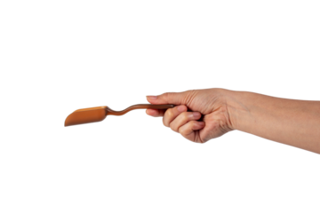 Brown plastic spoon in hand, isolated on transparent background