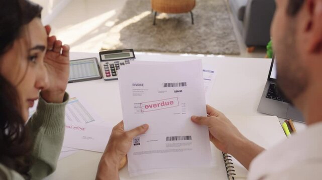 Couple facing overdue bills and financial pressure at home, stressed by inflation and economy recession