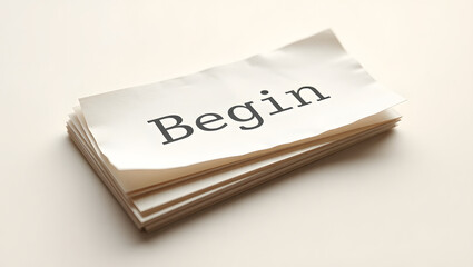 Stack of Papers with 'Begin' Inscribed A New Start Concept