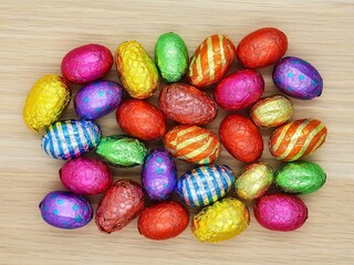 Group of colored chocolate Easter eggs in top view . Easter concept.
