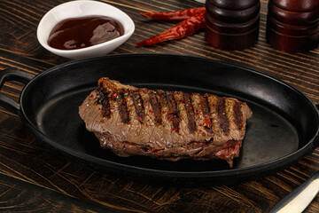 Grilled beef striploin steak with sauce