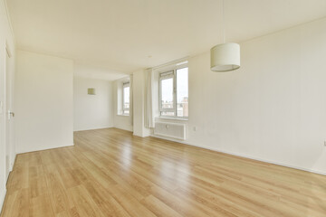 Bright, minimalist interior featuring wooden flooring and large windows. The space exudes a clean, airy atmosphere ideal for relaxation or creativity.