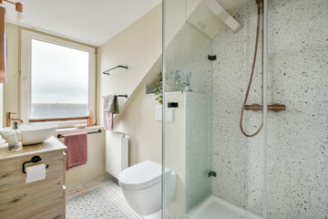A chic bathroom featuring a blend of modern fixtures and natural light, accentuated by elegant decor and a spacious layout for ultimate relaxation.