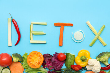 Composition with word DETOX and fresh vegetables on color background