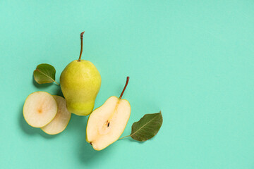 Sweet ripe pears and leaves on turquoise background