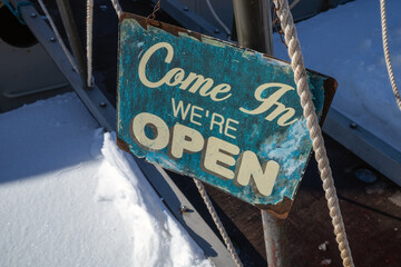 Come In We're Open Sign outdoors in sunlight