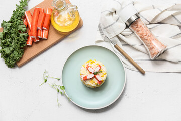 Plate of salad with crab sticks and corn on white background