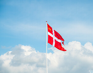 Danish flag with cloudy and blue sky